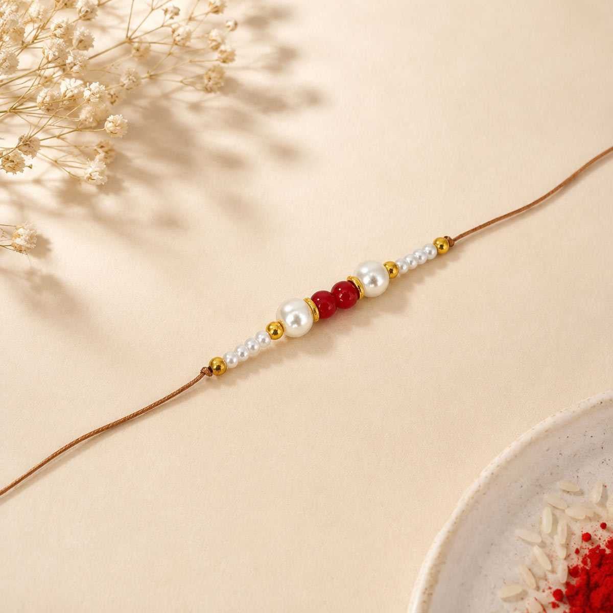 Elegant Pearl Rakhi with Red Beads - Flowers to Nepal - FTN